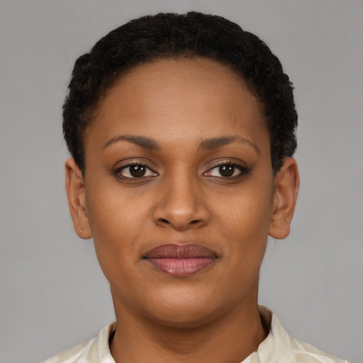 Joyful black young-adult female with short  brown hair and brown eyes