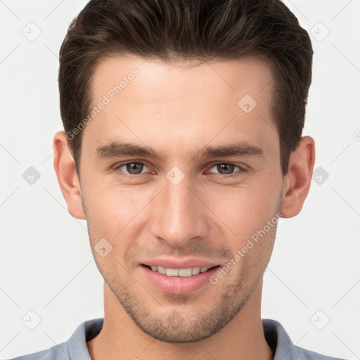 Joyful white young-adult male with short  brown hair and brown eyes