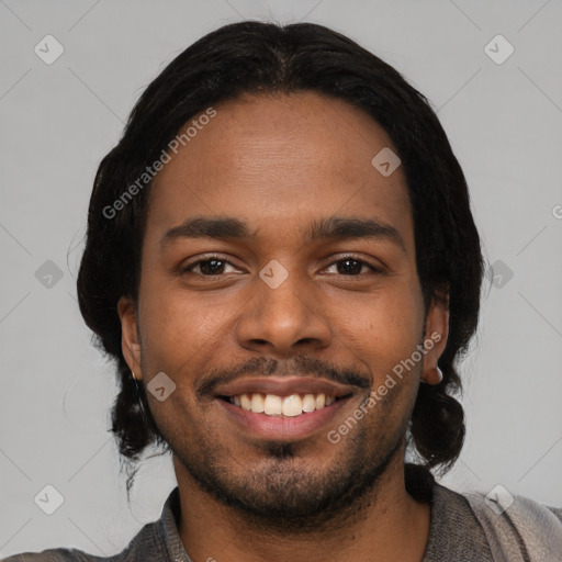 Joyful black young-adult male with short  black hair and brown eyes