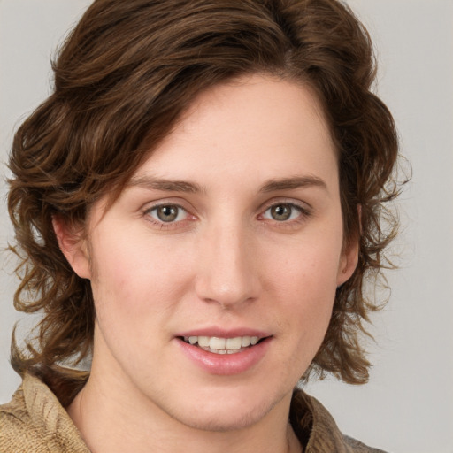 Joyful white young-adult female with medium  brown hair and blue eyes