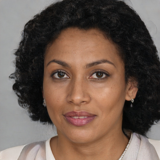 Joyful black young-adult female with medium  brown hair and brown eyes