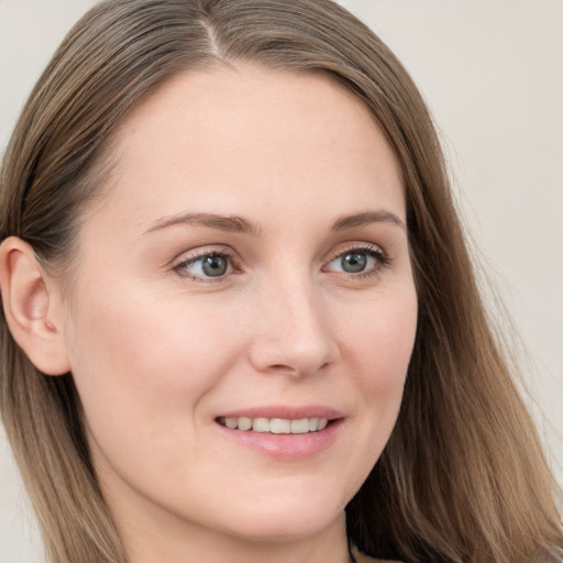 Joyful white young-adult female with long  brown hair and grey eyes