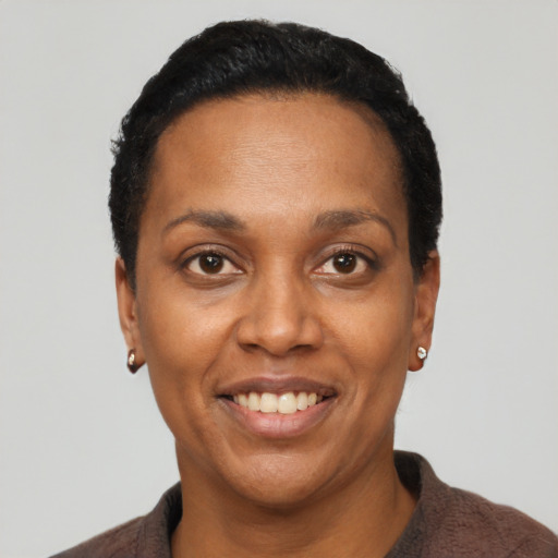 Joyful black adult female with short  black hair and brown eyes