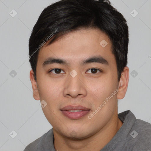 Joyful asian young-adult male with short  black hair and brown eyes