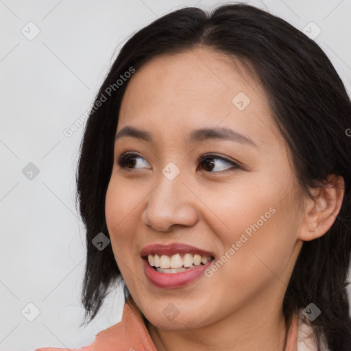 Joyful asian young-adult female with long  brown hair and brown eyes