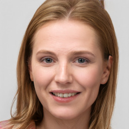 Joyful white young-adult female with long  brown hair and blue eyes