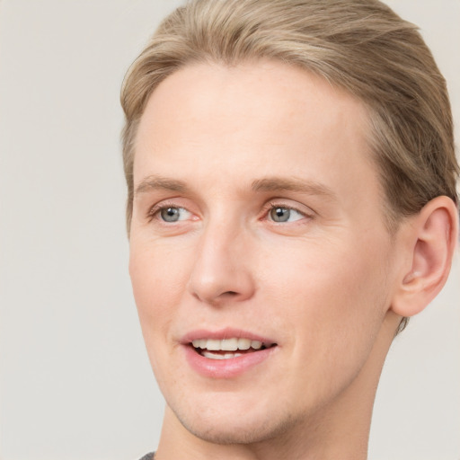 Joyful white young-adult male with short  brown hair and blue eyes