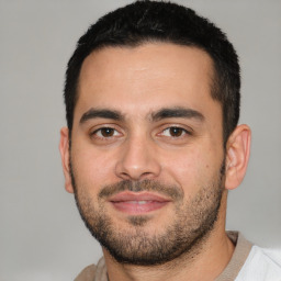 Joyful white young-adult male with short  black hair and brown eyes