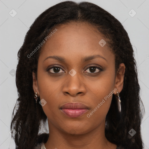 Joyful black young-adult female with long  brown hair and brown eyes