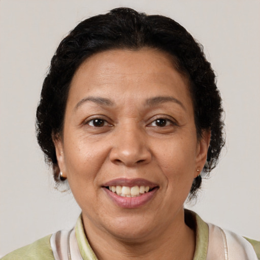 Joyful latino adult female with medium  brown hair and brown eyes