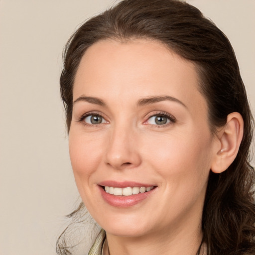 Joyful white adult female with long  brown hair and brown eyes