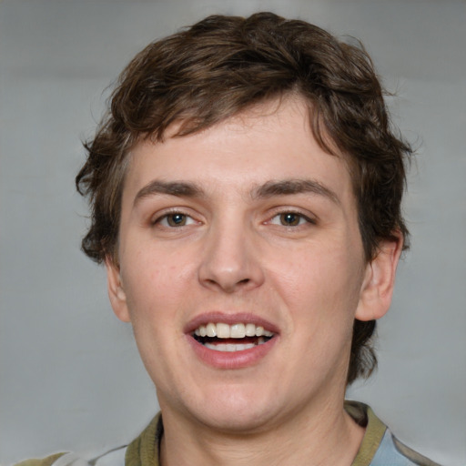 Joyful white young-adult male with medium  brown hair and grey eyes