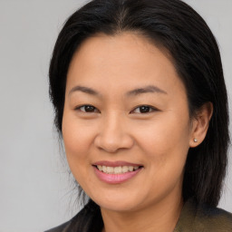 Joyful asian young-adult female with long  brown hair and brown eyes