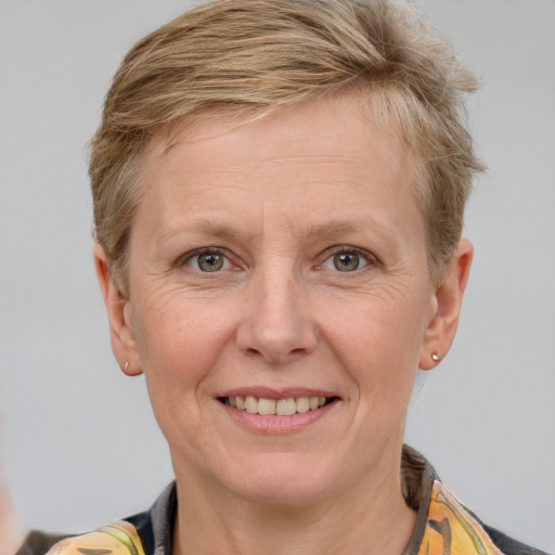 Joyful white adult female with short  brown hair and grey eyes