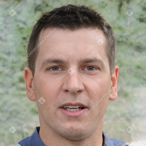 Joyful white adult male with short  brown hair and brown eyes