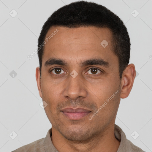 Joyful latino young-adult male with short  black hair and brown eyes