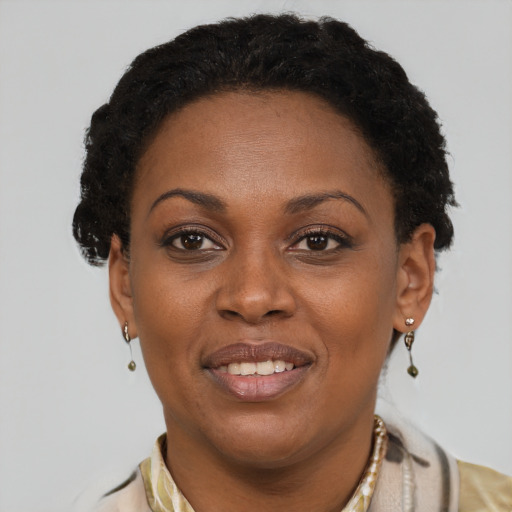 Joyful black young-adult female with short  brown hair and brown eyes