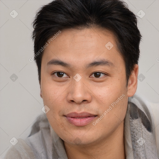 Joyful asian young-adult male with short  brown hair and brown eyes