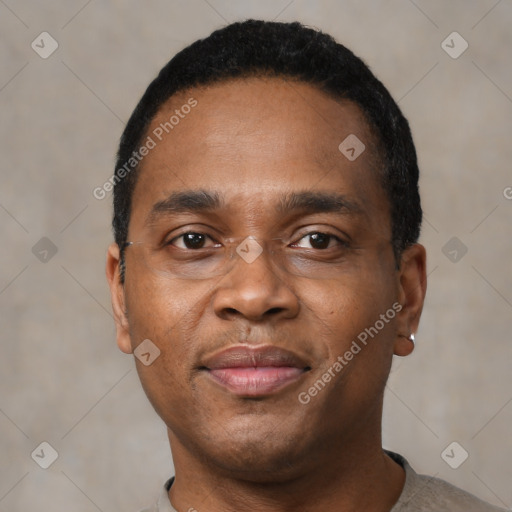 Joyful black adult male with short  black hair and brown eyes