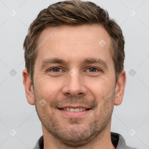 Joyful white adult male with short  brown hair and grey eyes