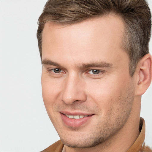 Joyful white adult male with short  brown hair and brown eyes