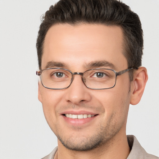 Joyful white young-adult male with short  brown hair and brown eyes