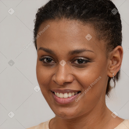 Joyful black young-adult female with short  brown hair and brown eyes