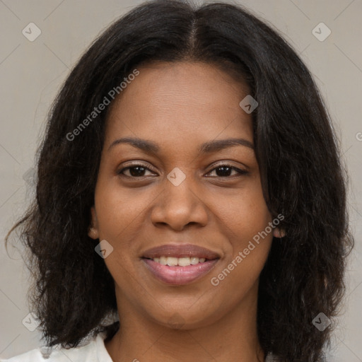 Joyful black young-adult female with long  brown hair and brown eyes