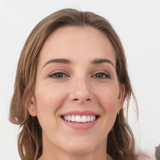 Joyful white young-adult female with long  brown hair and grey eyes