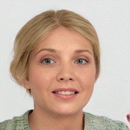 Joyful white young-adult female with medium  brown hair and blue eyes