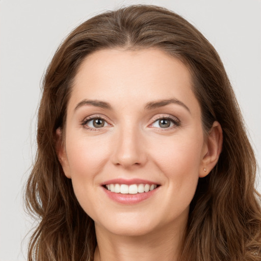 Joyful white young-adult female with long  brown hair and grey eyes