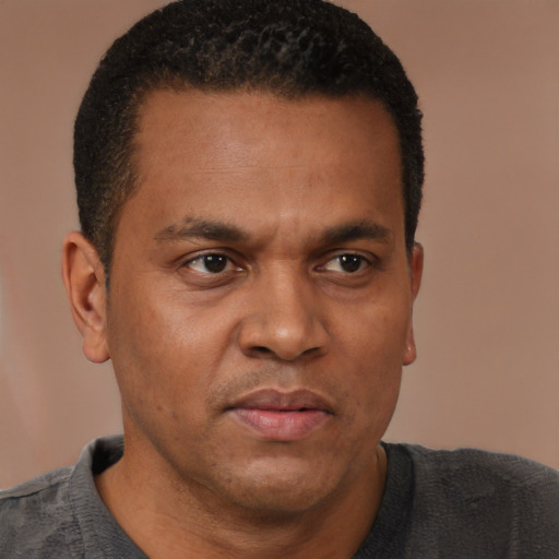 Neutral latino adult male with short  brown hair and brown eyes