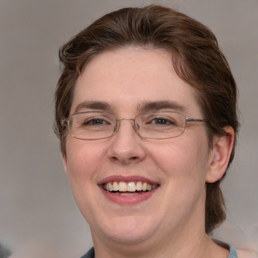 Joyful white adult female with medium  brown hair and blue eyes