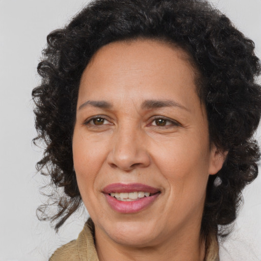 Joyful latino adult female with medium  brown hair and brown eyes