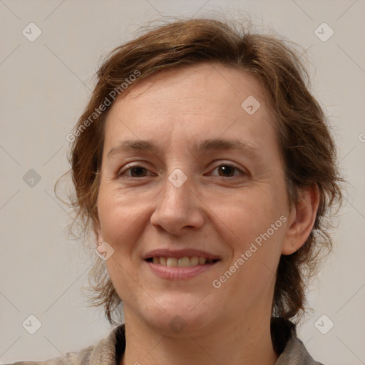 Joyful white adult female with medium  brown hair and grey eyes