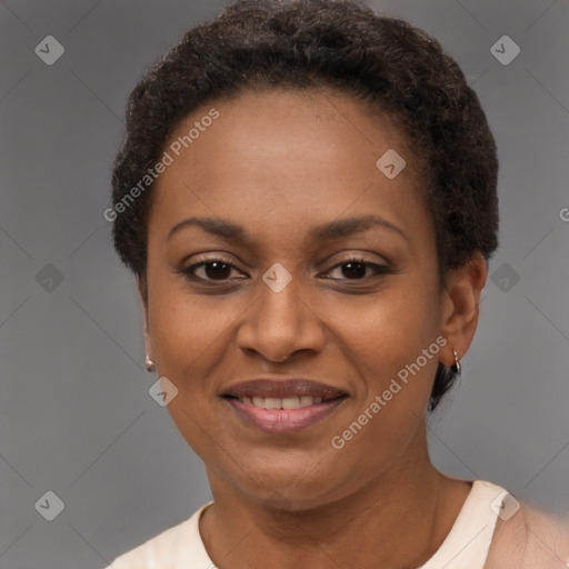 Joyful black adult female with short  brown hair and brown eyes