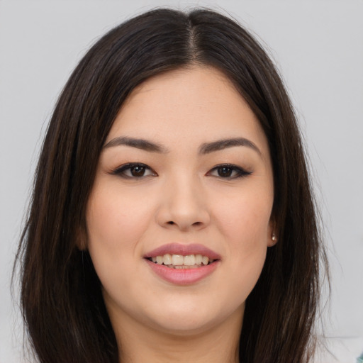 Joyful white young-adult female with long  brown hair and brown eyes