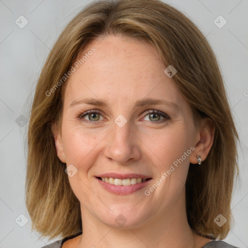 Joyful white adult female with medium  brown hair and grey eyes