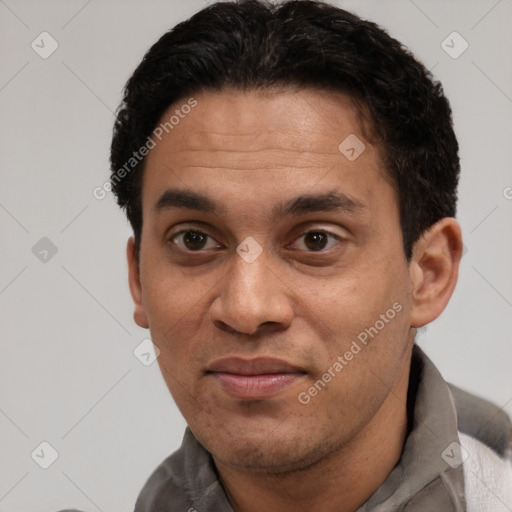 Joyful white adult male with short  black hair and brown eyes