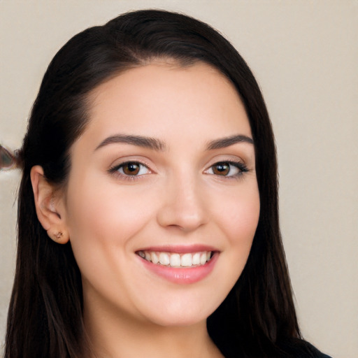 Joyful white young-adult female with long  black hair and brown eyes