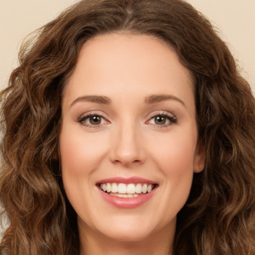 Joyful white young-adult female with long  brown hair and green eyes