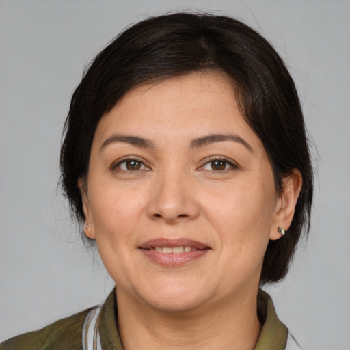 Joyful white adult female with medium  brown hair and brown eyes