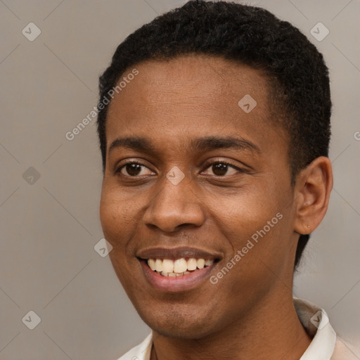 Joyful black young-adult male with short  black hair and brown eyes