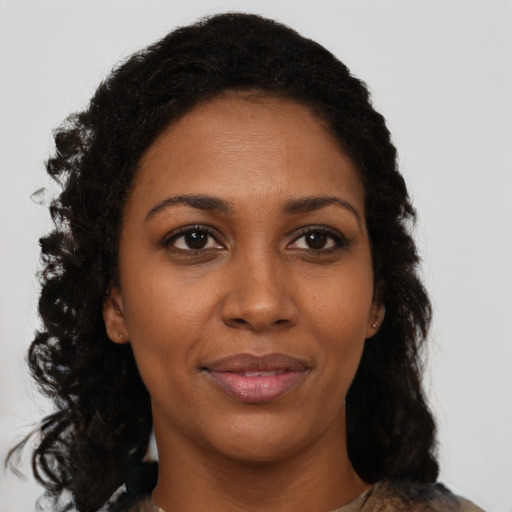 Joyful black young-adult female with medium  black hair and brown eyes