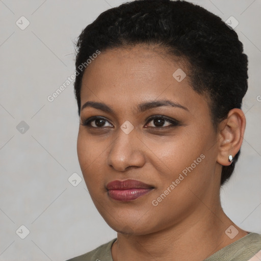 Joyful black young-adult female with short  black hair and brown eyes