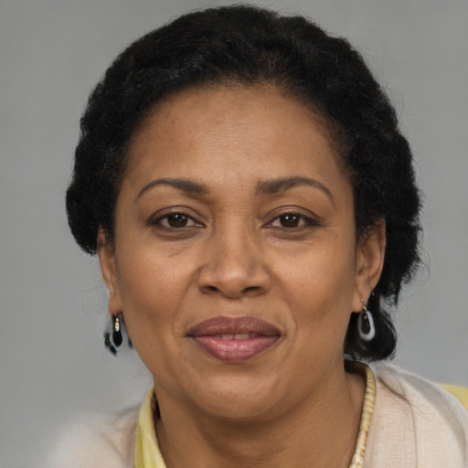 Joyful latino adult female with short  brown hair and brown eyes