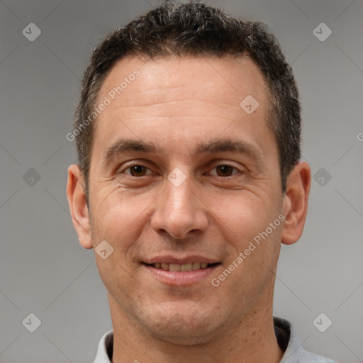 Joyful white adult male with short  brown hair and brown eyes