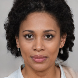 Joyful latino adult female with medium  brown hair and brown eyes