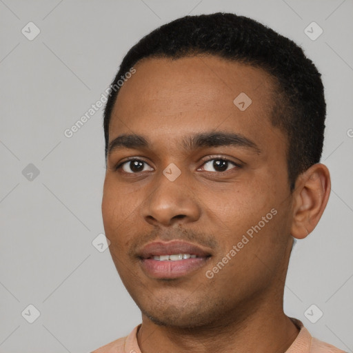 Joyful black young-adult male with short  black hair and brown eyes