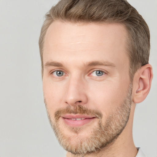 Joyful white adult male with short  brown hair and grey eyes